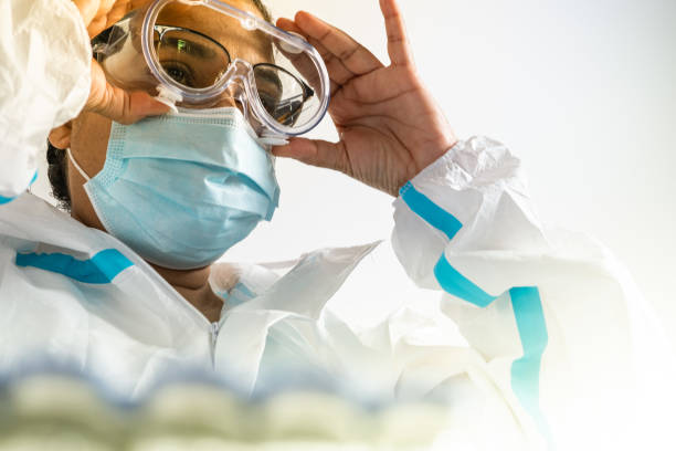 Healthcare worker wearing certified safety goggles during medical procedure Healthcare worker wearing certified safety goggles during medical procedure